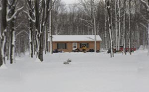 Winter Exterior shot of Porcupine Lake Cottage Rental Available Year Round Up North in Gaylord, Michigan. Rent our cozy and clean cottage for the Weekend, Week, or more!